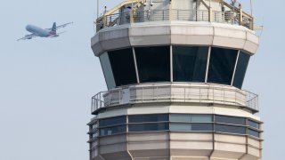 An American Airlines Airbus A319 airplane takes off past the air traffic control tower at Ronald Reagan Washington National Airport in Arlington, Virginia, January 11, 2023