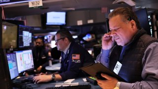 Traders work on the floor of the New York Stock Exchange during morning trading on January 17, 2023 in New York City.