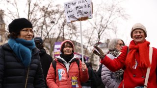 A protester holds a placard reading “I don’t want to die on stage” during an anti-pension reform rally in Paris on January 19, 2023.
