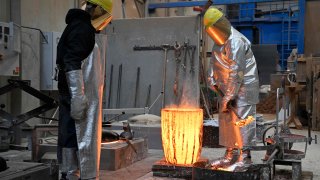 Craftsmen work on cast metal for the production of an art work at the Hermann Noack fine art foundry’s production site in Berlin on January 24, 2023. A January Ifo survey showed improved sentiment among German businesses.