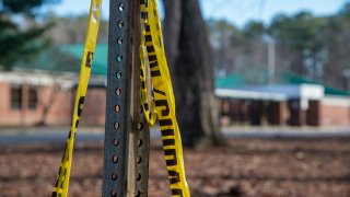 Police tape hangs from a sign post outside Richneck Elementary School following a shooting on Jan. 7, 2023, in Newport News, Virginia.