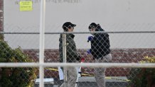 Investigators work near the scene of a mass shooting in Monterey Park, California, on January 22, 2023. - Ten people have died and at least 10 others have been wounded in a mass shooting in a largely Asian city in southern California, police said, with the suspect still at large hours later. (Photo by Robyn BECK / AFP) (Photo by ROBYN BECK/AFP via Getty Images)