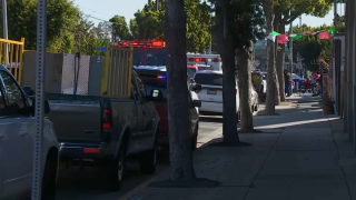 A fire truck and ambulance parked on an East Los Angeles street.
