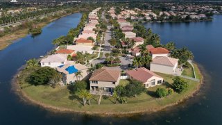 An aerial view from a drone shows homes in a neighborhood on January 26, 2021 in Miramar, Florida. According to two separate indices existing home prices rose to the highest level in 6 years.