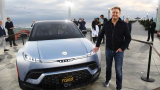 Henrik Fisker stands with the Fisker Ocean electric vehicle after it was unveiled at the Manhattan Beach Pier ahead of the Los Angeles Auto Show and AutoMobilityLA on November 16, 2021 in Manhattan Beach, California.