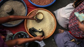 India’s finance minister will present the annual budget to parliament on Wednesday. Seen here is a roadside vendor selling rice in Mumbai, India.