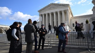 People wait in line outside the US Supreme Court in Washington, DC, on February 21, 2023 to hear oral arguments in two cases that test Section 230, the law that provides tech companies a legal shield over what their users post online.