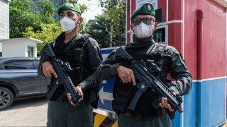 FILE - Bangkok police officers seen standing on guard