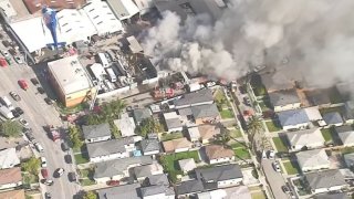 Firefighters battle a fire at a commercial building in Lynwood.