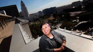Gloria Molina is pictured with LA City Hall in the background.