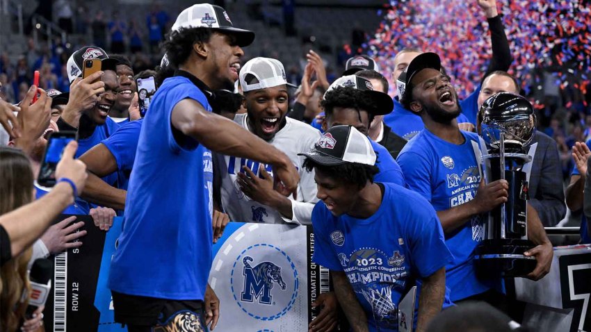 The Memphis Tigers celebrate after punching their ticket to the NCAA tournament by defeating the Houston Cougars in the American Athletic Conference Tournament Championship at Dickies Arena.