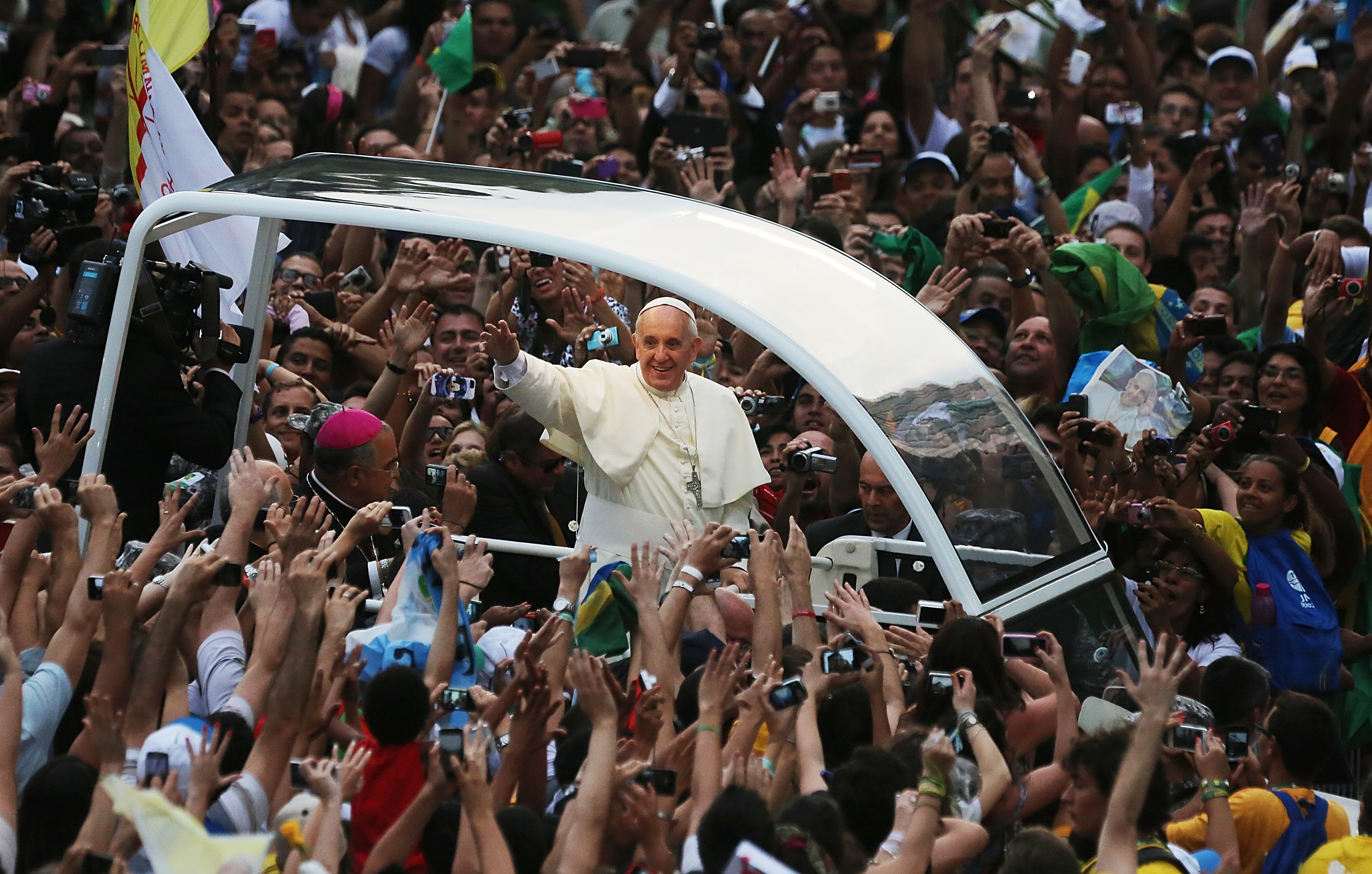 Pope Francis waves to the crowd while departing the Metropolitan Cathedral in the Popemobile after arriving on July 22, 2013 in Rio de Janeiro, Brazil. More than 1.5 million pilgrims were expected to join Pope Francis for his visit to the Catholic Church’s World Youth Day celebrations. Pope Francis was scheduled to visit Brazil from July 22 to 28.