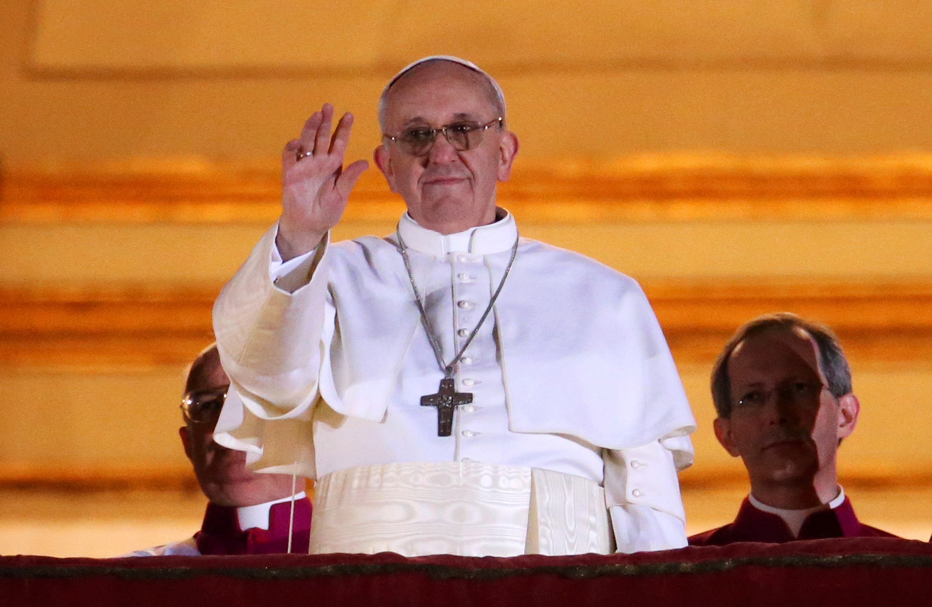Newly elected Pope Francis I waves to the waiting crowd from the central balcony of St Peter’s Basilica on March 13, 2013 in Vatican City, Vatican. Argentinian Cardinal Jorge Mario Bergoglio was elected as the 266th Pontiff and led the world’s 1.2 billion Catholics.