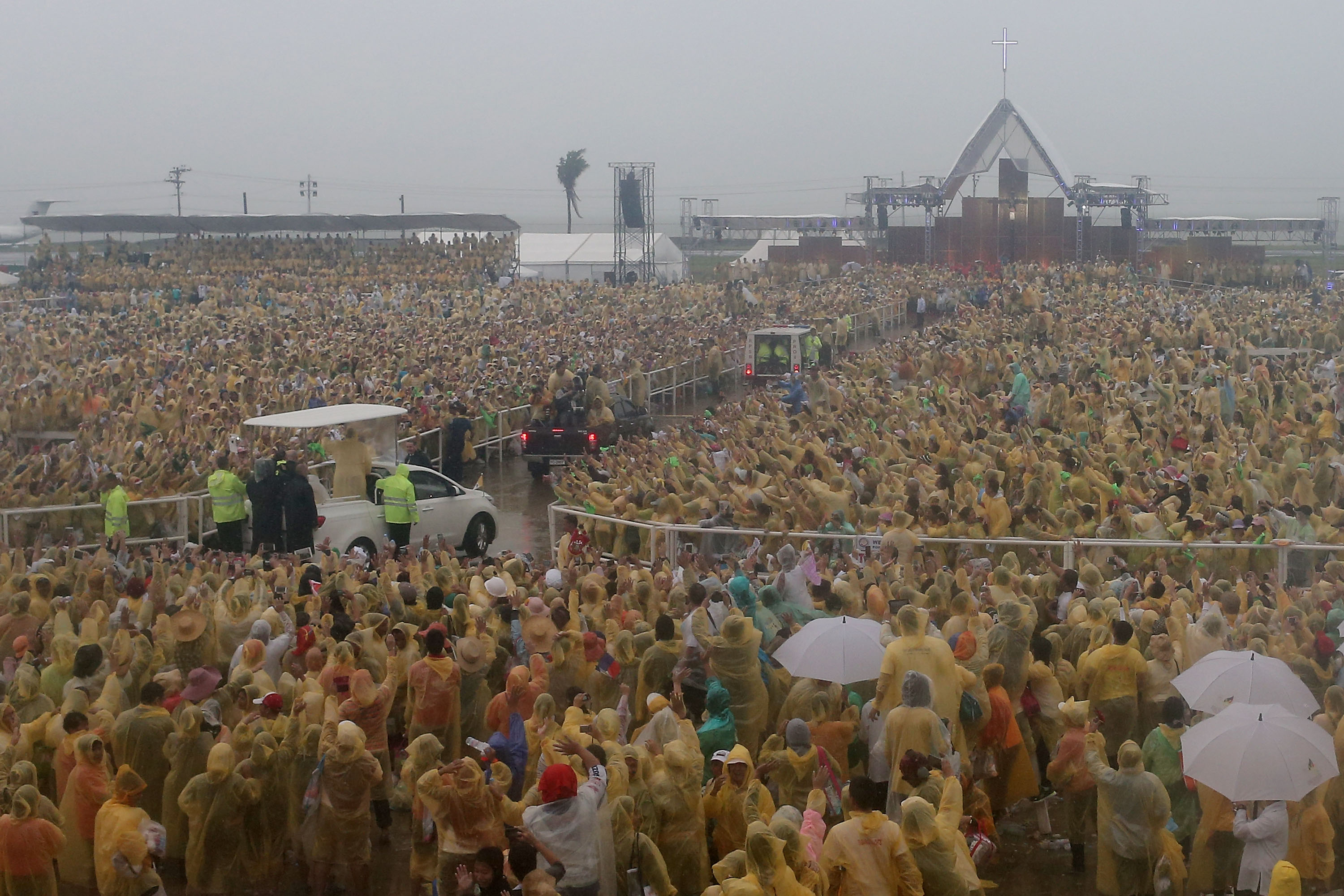 Pope Francis waves to the crowd after conducting mass at the Tacloban Airport on Jan. 17, 2015 in Tacloban, Leyte, Philippines. Pope Francis is visited venues across Leyte and Manila during his visit to the Philippines from January 15 – 19. The visit attracted crowds in the millions as Filipino Catholics flocked to catch a glimpse of the leader of the Catholic Church in the Philippines for the first time since 1995. The Pope was in Tacloban for one day to visit areas devastated by Typhoon Haiyan before he returned to Manila and held a mass at Rizal Park. The Philippines is the only Catholic majority nation in Asia with around 90% of the population professing the faith.