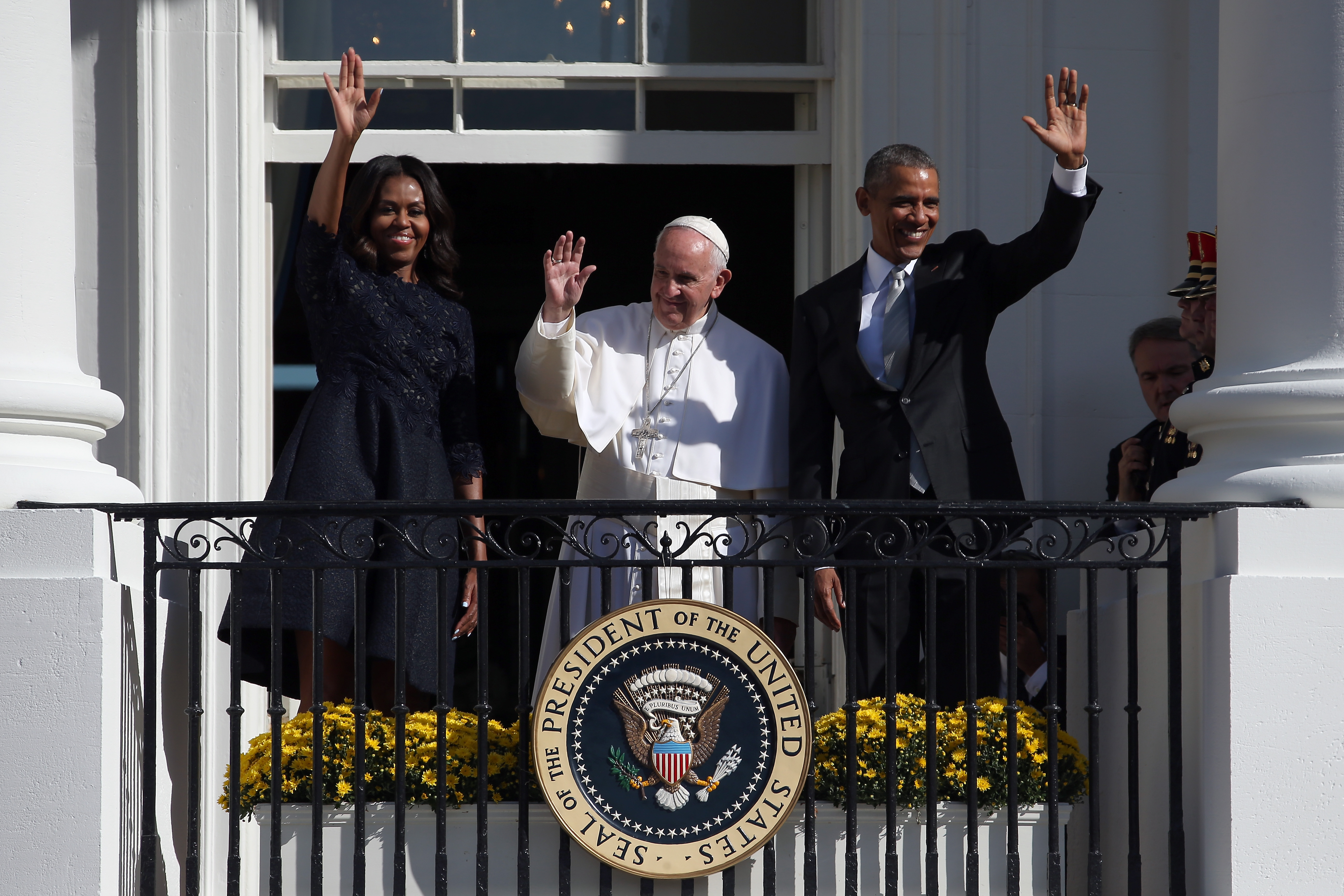 Former President Obama and former first Lady Michelle Obama wave from the balcony with Pope Francis in an arrival ceremony at the White House on Sept. 23, 2015 in Washington, DC. The Pope began his first trip to the United States at the White House followed by a visit to St. Matthew’s Cathedral, and then held a Mass on the grounds of the Basilica of the National Shrine of the Immaculate Conception.
