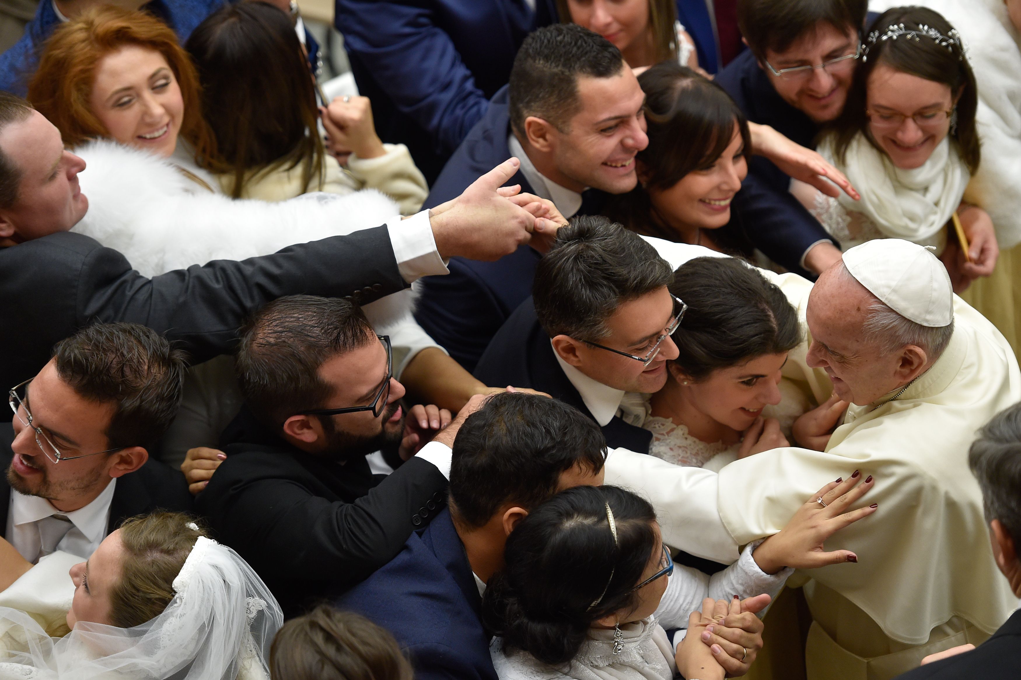Pope Francis greets newlyweds during his weekly general audience at Aula Paolo VI in the Vatican on Dec. 27, 2017.