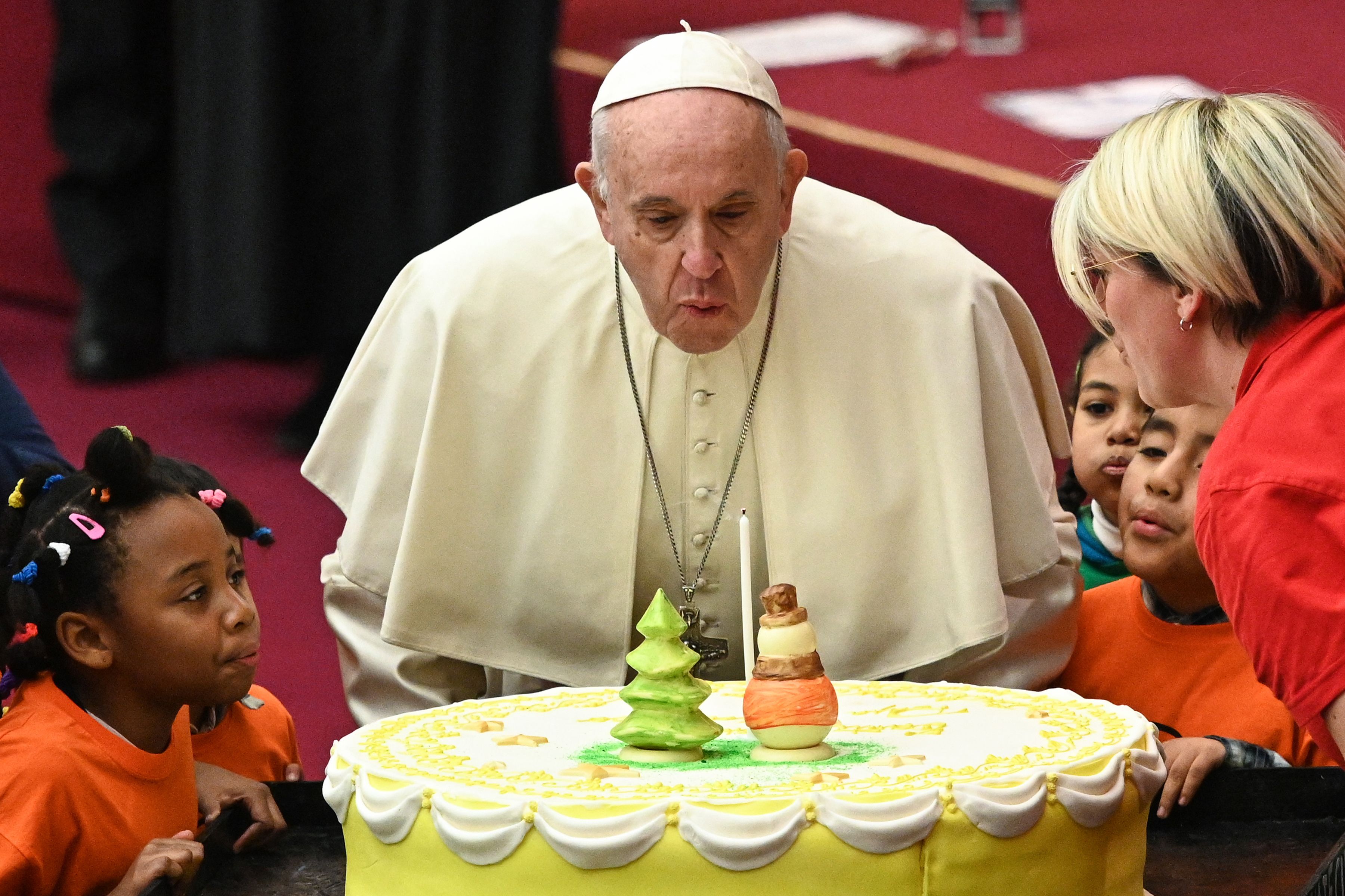 Pope Francis blows the candle of cake for his 82nd birthday, offered to him during an audience for children and families of the Santa Marta dispensary on Dec. 16, 2018 at the Vatican. Pope Francis turned 82 on Dec. 17, 2018.