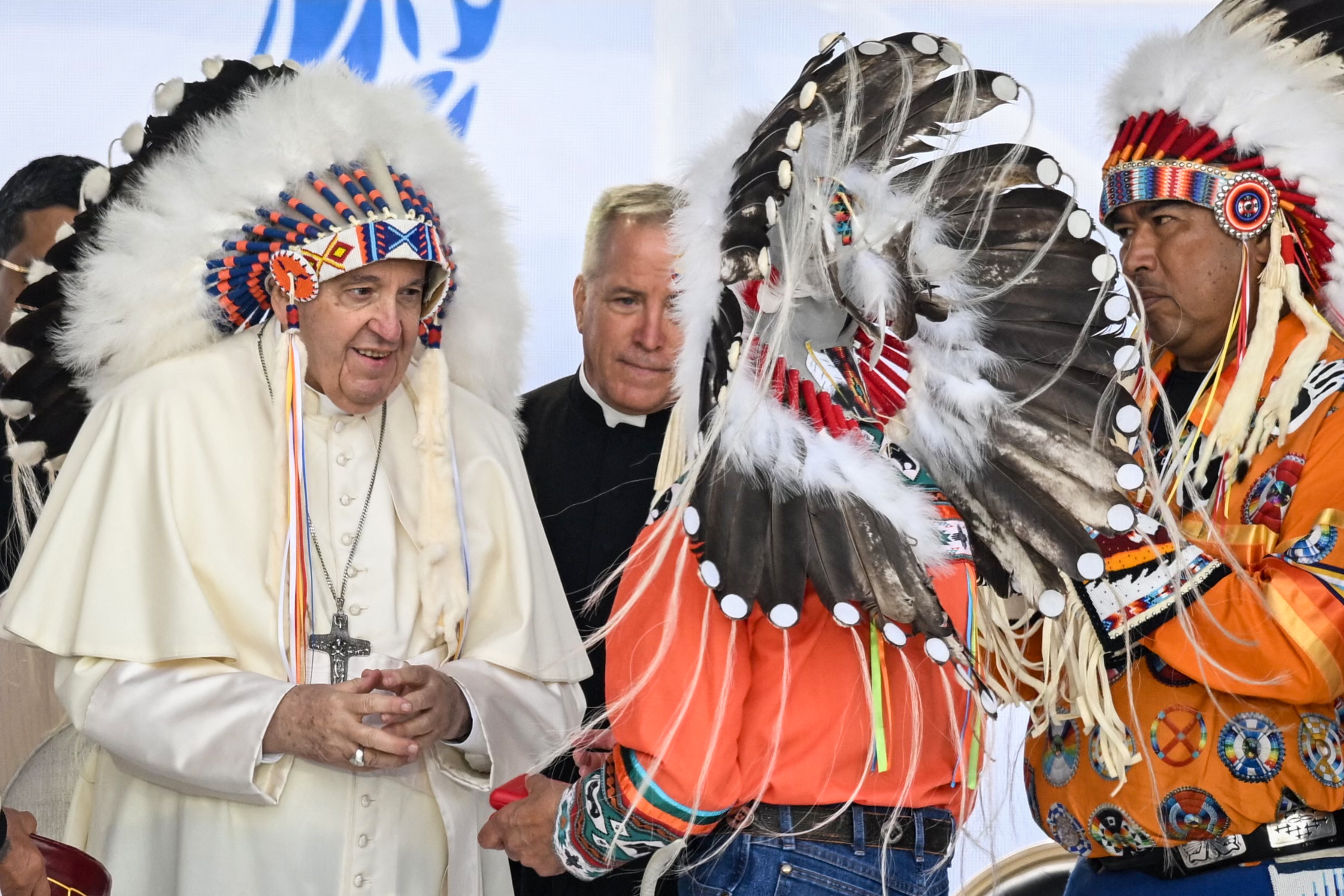 Pope Francis wears a headdress presented to him by Indigenous leaders during a meeting at Muskwa Park in Maskwacis, Alberta, Canada, on July 25, 2022. Pope Francis made a historic personal apology to Indigenous survivors of child abuse committed over decades at Catholic-run institutions in Canada, at the start of a week-long visit he has described as a “penitential journey.”