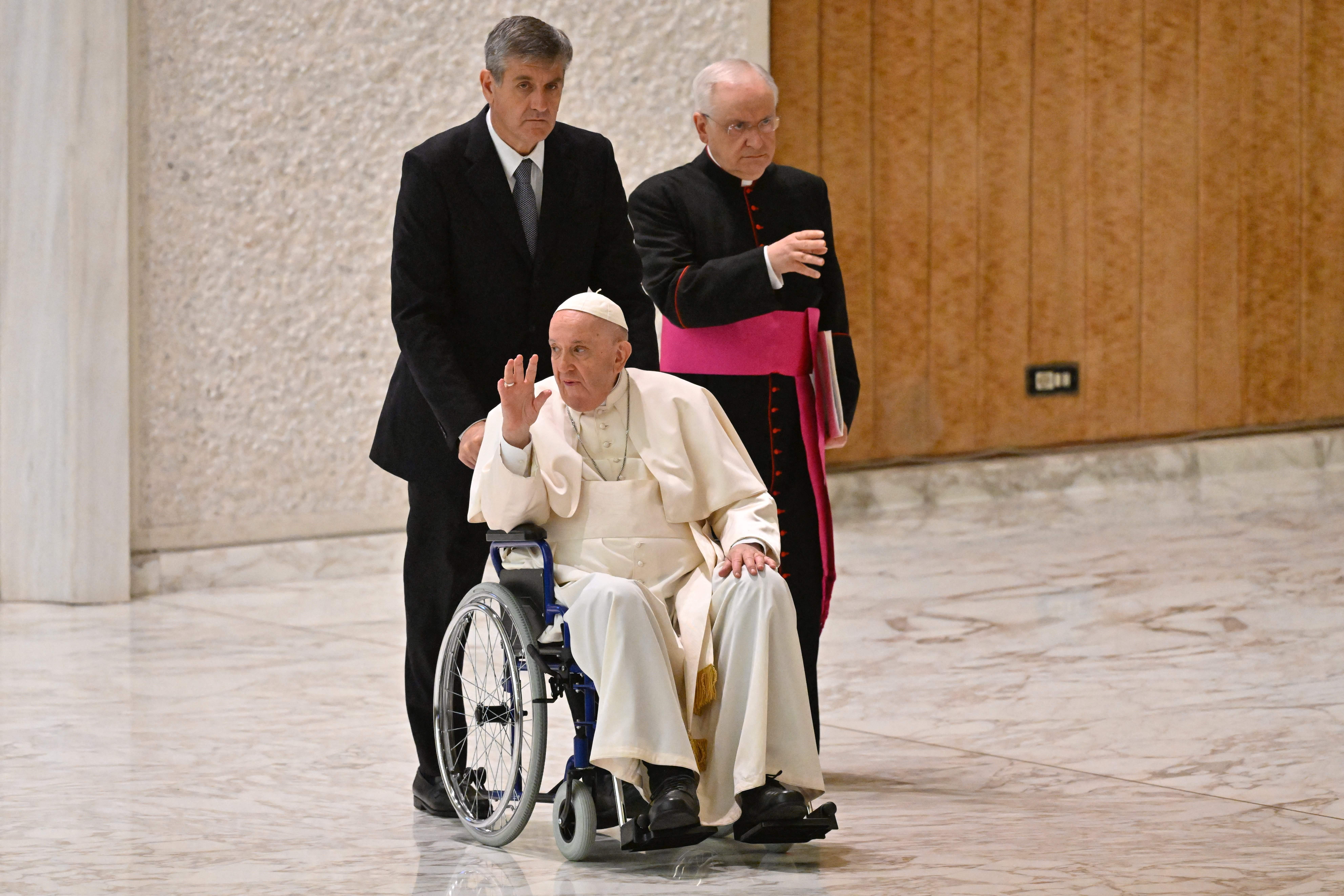 Pope Francis arrives on wheelchair during the audience to the Participants to Plenary Assembly of the International Union of Superiors General in the Paul VI hall at the Vatican,  on May 5, 2022 .