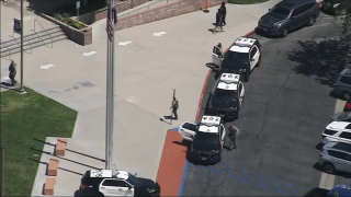 An aerial shot shows police SUVs parked at Valencia High School.