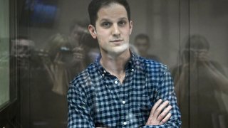 US journalist Evan Gershkovich, arrested on espionage charges, stands inside a defendants’ cage before a hearing to consider an appeal on his arrest at the Moscow City Court in Moscow on April 18, 2023. 