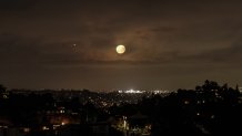 LOS ANGELES, CALIFORNIA, USA - JULY 14: The Supermoon rises above the Hollywood Hills in Los Angeles, California on July 14, 2022. (Photo by Emily Molli/Anadolu Agency via Getty Images)