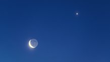 The Waning Crescent Moon with bright Earthshine along with bright Venus in pre-dawn skies.  Long exposure.