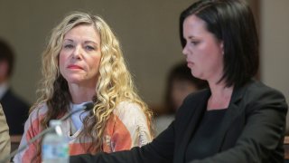 FILE - Lori Vallow Daybell glances at the camera during her hearing in Rexburg, Idaho., on March 6, 2020.