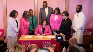 Michigan Gov. Gretchen Whitmer signs legislation to repeal the 1931 abortion ban statute, which criminalized abortion in nearly all cases, during a bill signing ceremony, April 5, 2023, in Birmingham, Mich.
