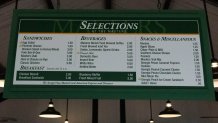 Apr 3, 2023; Augusta, Georgia, USA; A menu hangs in a concession area during a practice round for The Masters golf tournament at Augusta National Golf Club. Mandatory Credit: Kyle Terada-USA TODAY Network