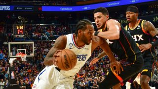 Devin Booker #1 of the Phoenix Suns plays defense during the game against Kawhi Leonard #2 of the LA Clippers during round one game two of the 2023 NBA Playoffs on April 18, 2023 at Footprint Center in Phoenix, Arizona.