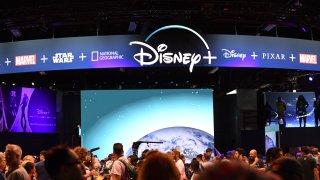 Attendees visit the Disney+ streaming service booth at the D23 Expo on August 23, 2019 at the Anaheim Convention Center in Anaheim, California.