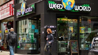 People walk past the Weed World store on March 31, 2021, in Midtown New York.