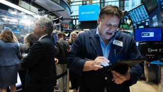 Traders work on the floor of the New York Stock Exchange (NYSE) on April 21, 2023.