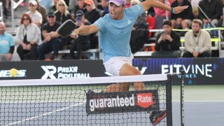 Ben Johns leaps across the kitchen for a backhand shot during the PPA Carvana Arizona Grand Slam Pro Men’s Doubles Championship match at Legacy Sports USA on February 19, 2023 in Mesa, Arizona.