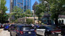 Emergency vehicles arrive on W. Peachtree in Atlanta, May 3, 2023. At least one person died, with four others injured, during a shooting in Atlanta's Midtown neighborhood.
