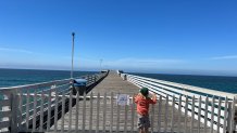 A child looks out at Crystal Pier, which was also closed for a portion of 2023.