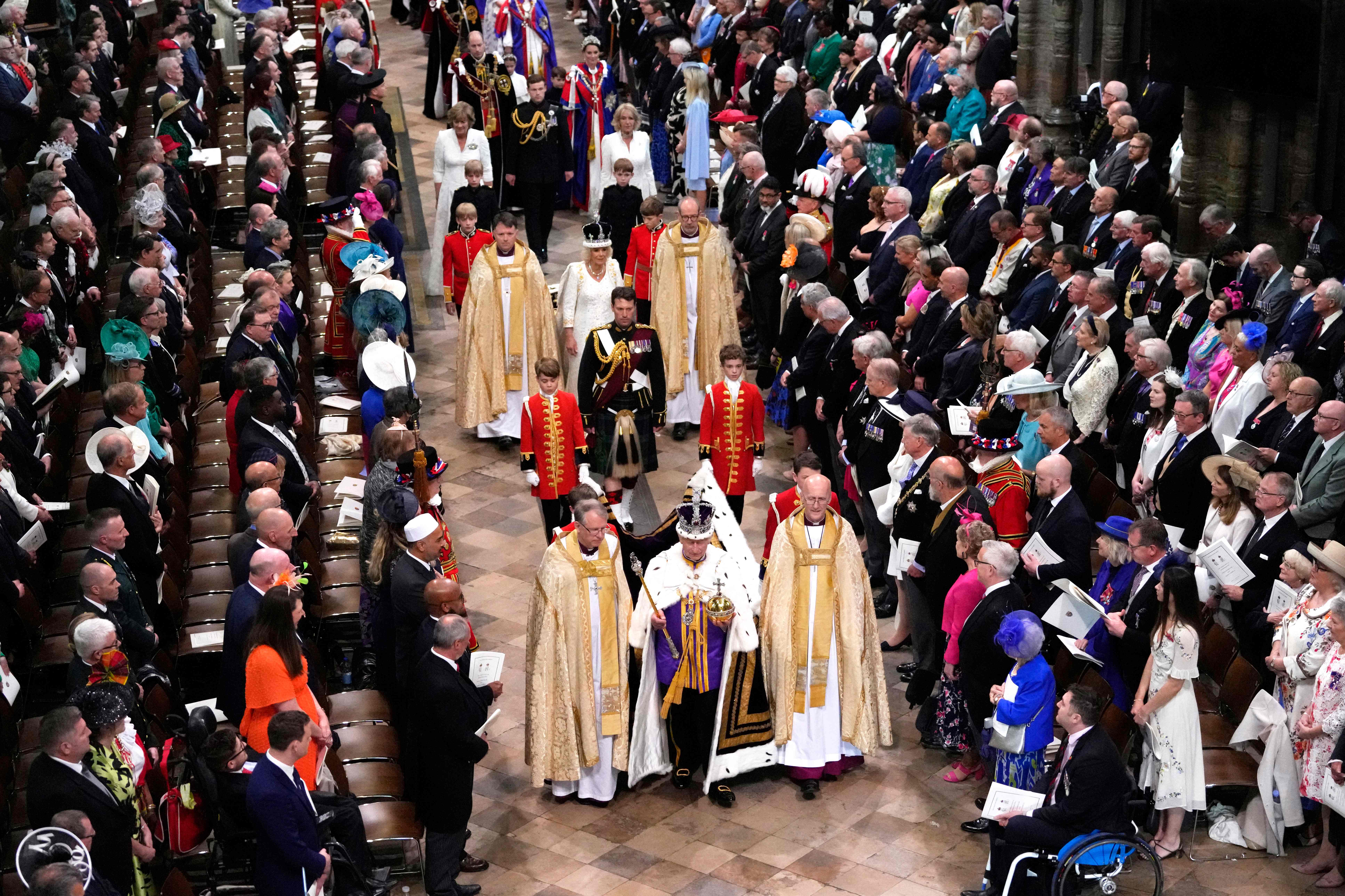 Britain’s King Charles III wearing the Imperial state Crown, and Queen Camilla, wearing a modified version of Queen Mary’s Crown leave Westminster Abbey after the Coronation Ceremonies in central London on May 6, 2023.