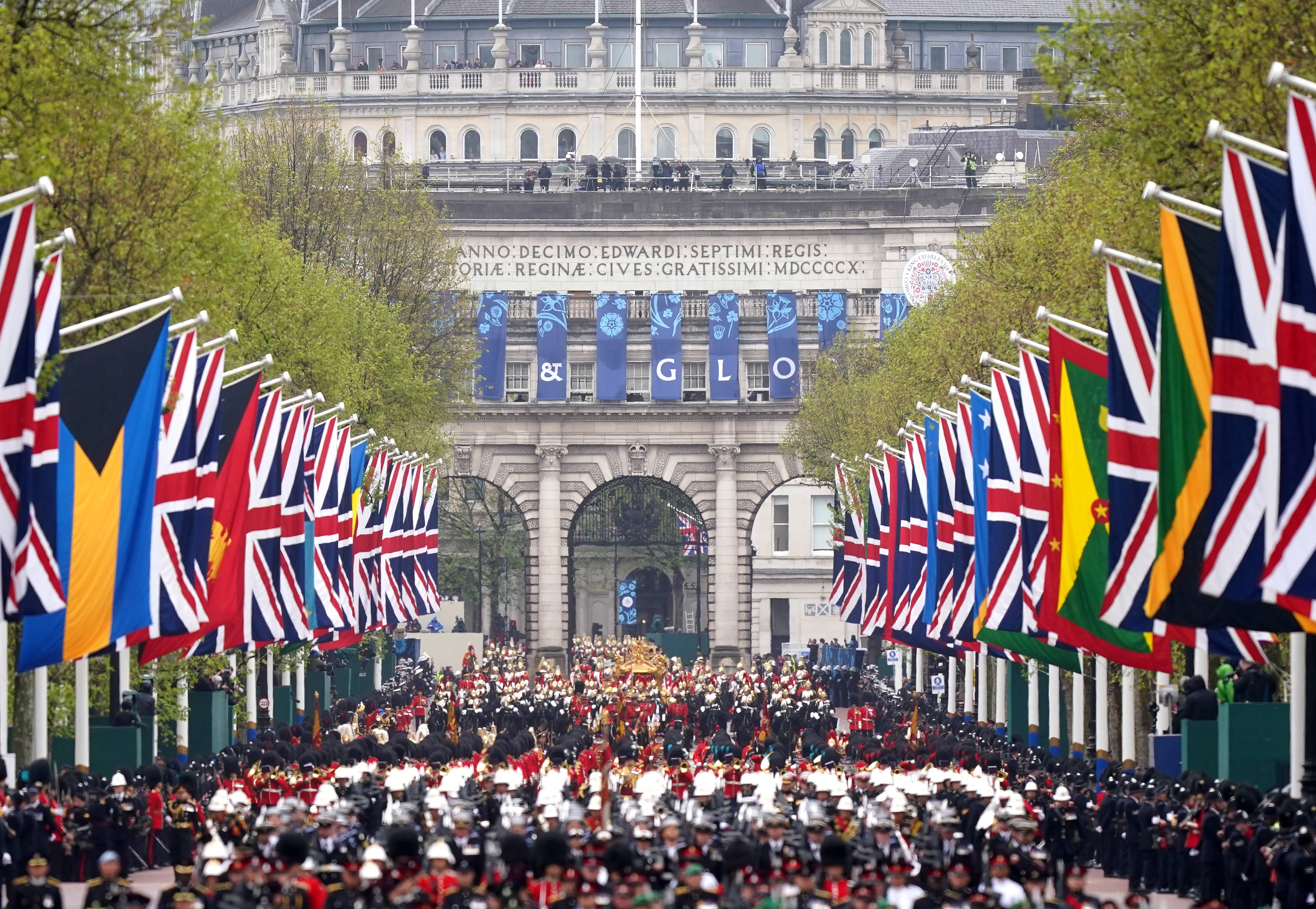 The Coronation Procession passes along The Mall to Buckingham Palace following the coronation ceremony of King Charles III and Queen Camilla in central London.