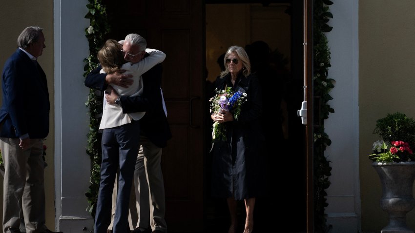 President Joe Biden gets a hug while next to first lady Dr. Jill Biden.