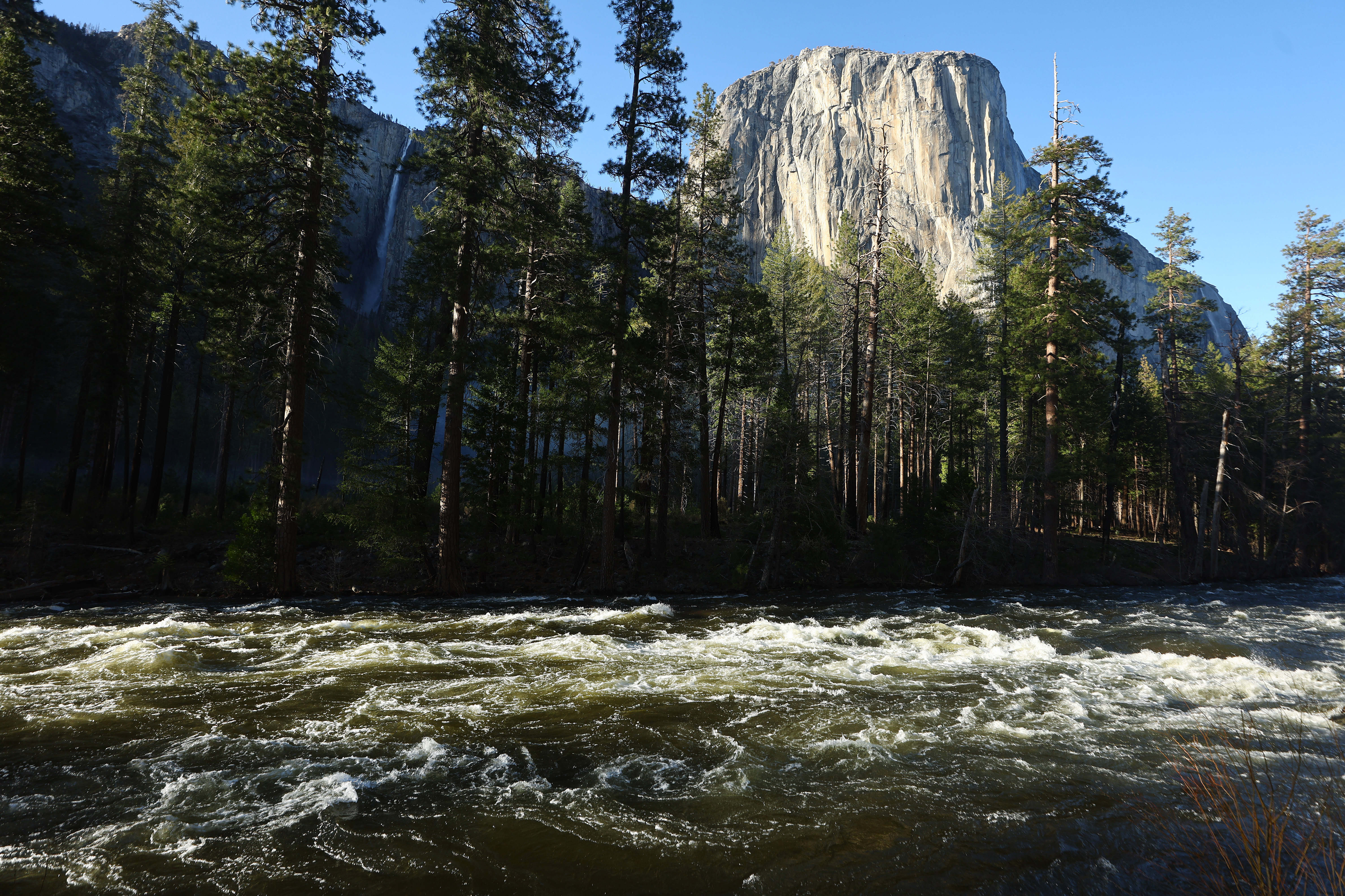 The snowmelt swollen Merced River flows past El Capitan in Yosemite Valley on April 28, 2023 in Yosemite National Park, California.