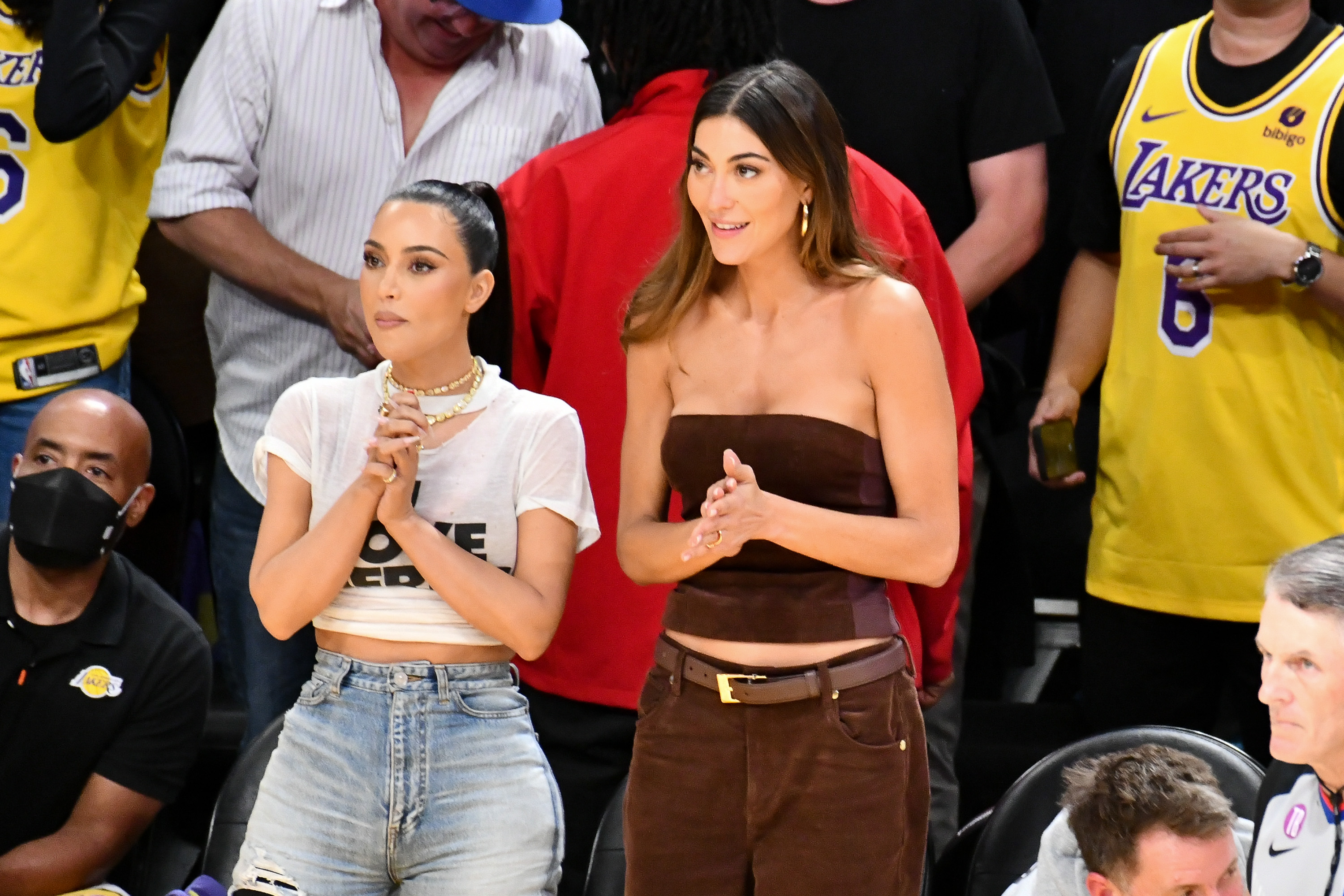 Kim Kardashian (L) and Sarah Staudinger attend a playoff baseketball game.