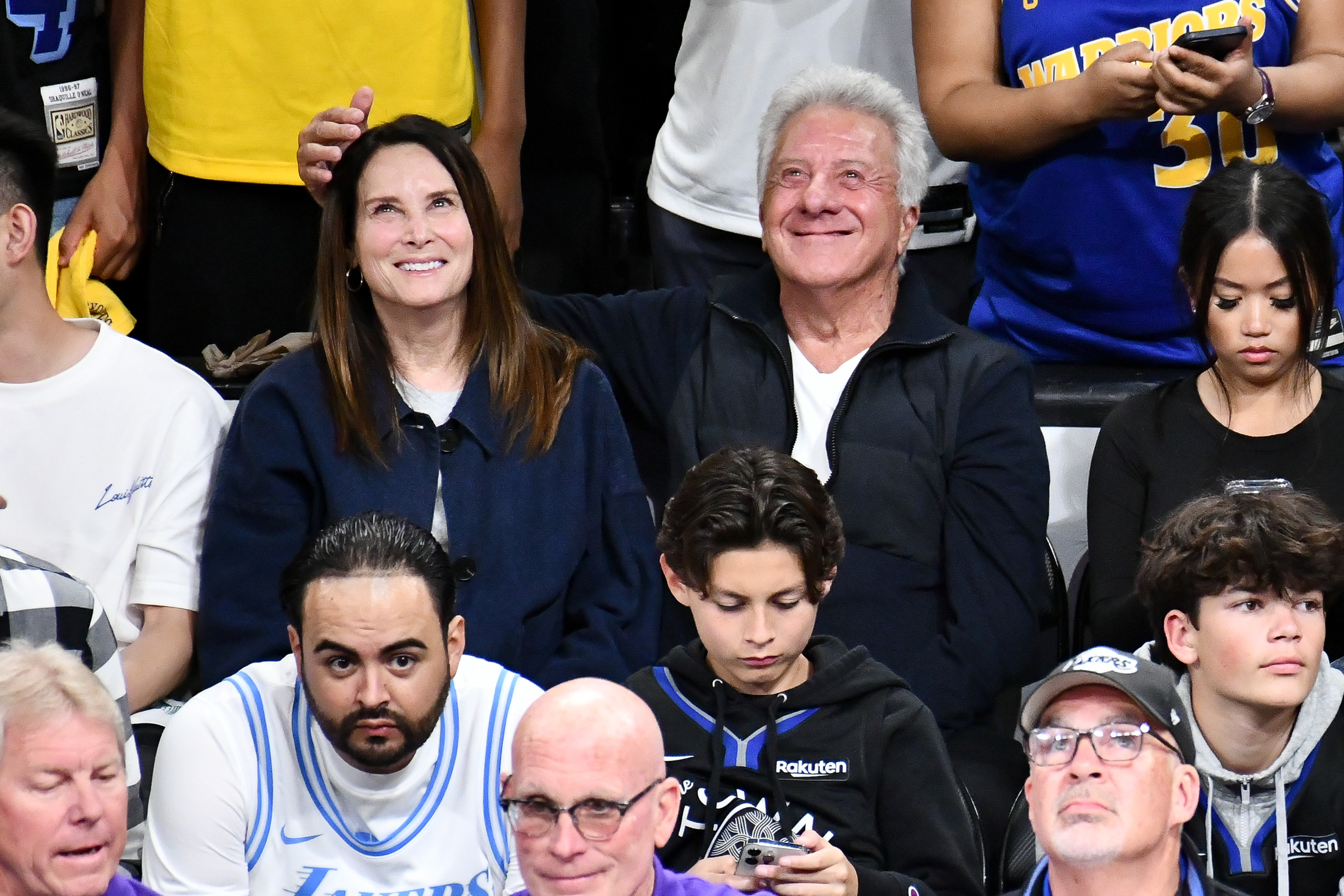 Dustin Hoffman and Lisa Hoffman attend a playoff basketball game.