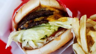 In-N-Out Burger's signature Double-Double cheeseburger and french fries are arranged for a photograph at a restaurant in Costa Mesa, California.