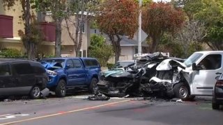 The scene of a crash that killed a woman and five dogs in Long Beach.