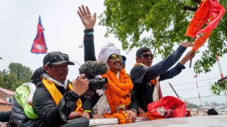 Hari Budha Magar, former Gurkha veteran and double amputee climber who scaled Mount Everest, is welcomed upon arrival at the airport in Kathmandu, Nepal, Tuesday, May 23, 2023.