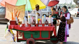 Pedestrians enjoying ice-cream on a hot summer day in Srinagar, Indian administered Kashmir.
