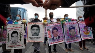 FILE – Relatives and classmates of the missing 43 Ayotzinapa college students march in Mexico City, Sept. 26, 2022, on the anniversary of their disappearance in Iguala, Guerrero state.