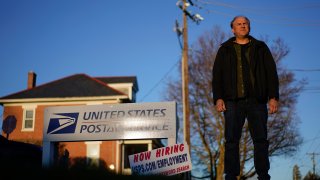 Gerald Groff, a former postal worker whose case was argued before the Supreme Court, stands near a “Now Hiring” sign posted at the roadside at the United State Postal Service, March 8, 2023, in Quarryville, Pa. (AP Photo/Carolyn Kaster, File)