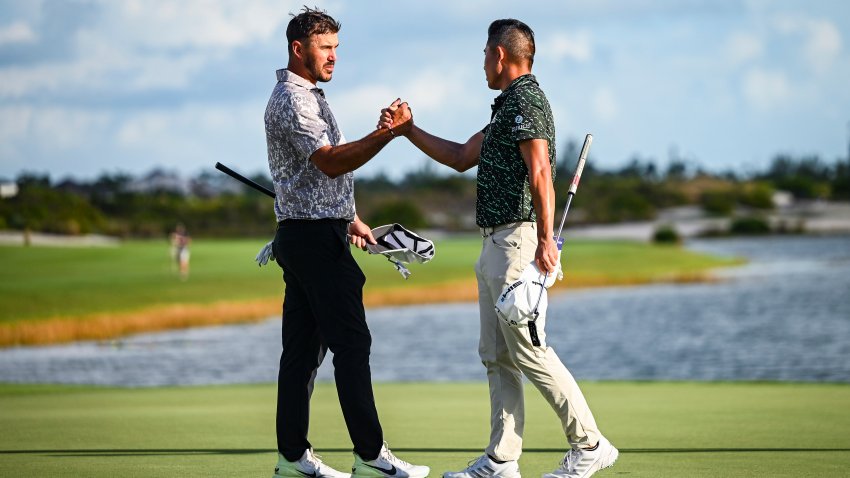 NASSAU, BAHAMAS – DECEMBER 05:  Brooks Koepka and Collin Morikawa shake hands on the 18th hole green following the final round of the Hero World Challenge at Albany on December 5, 2021, in Nassau, New Providence, Bahamas.